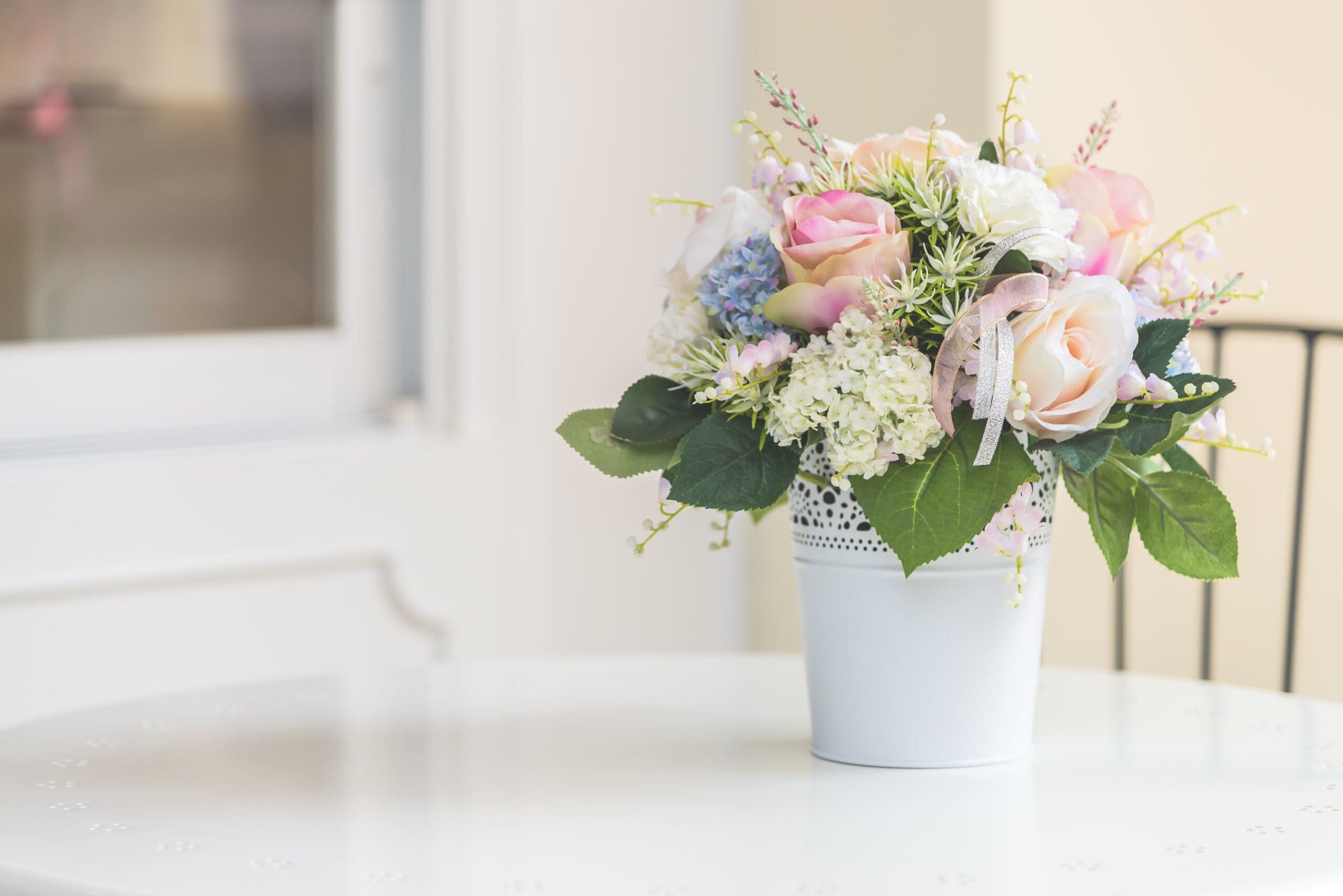 Vase of pink and white flowers on a table