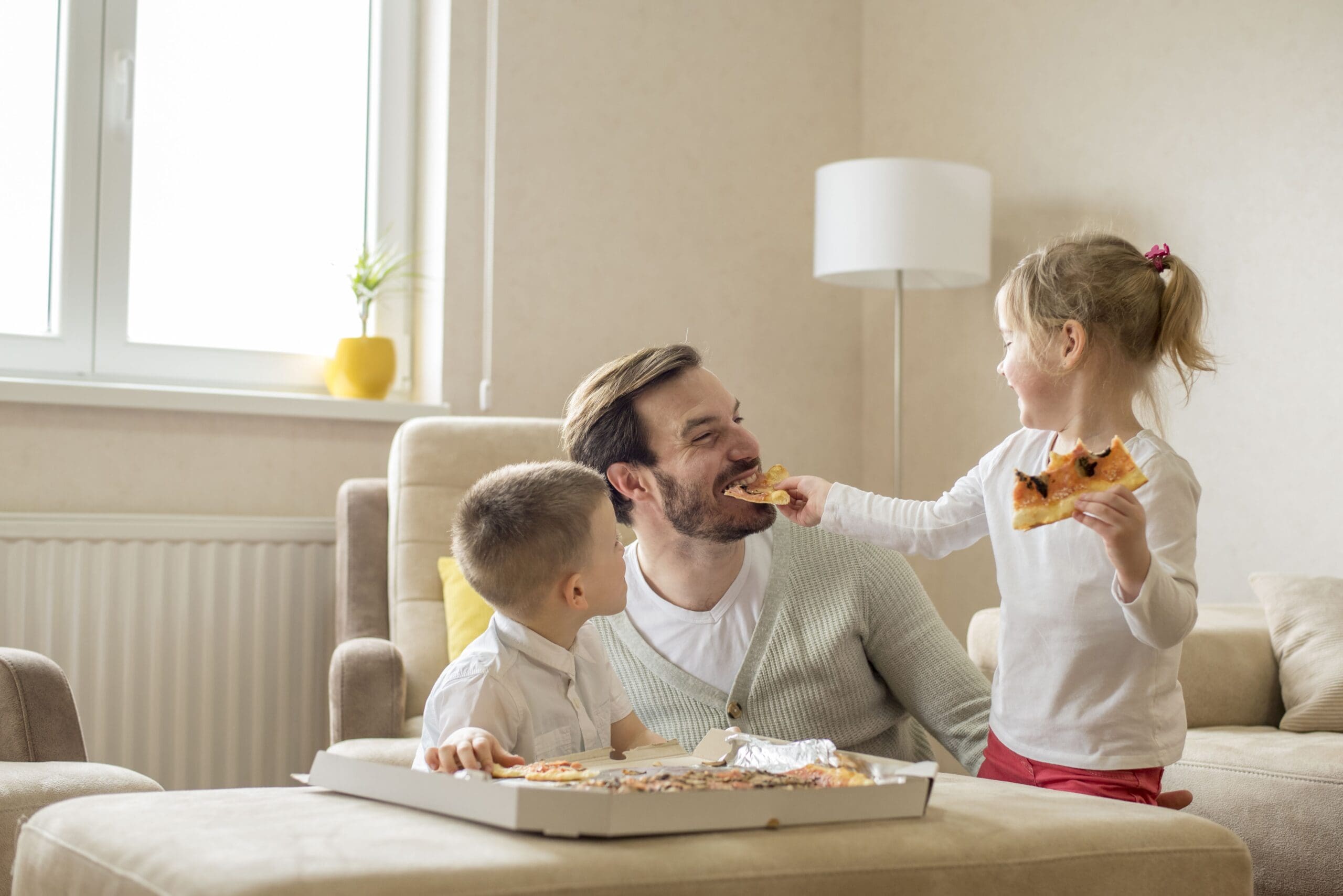 Family bonding over pizza in open floor plan of home