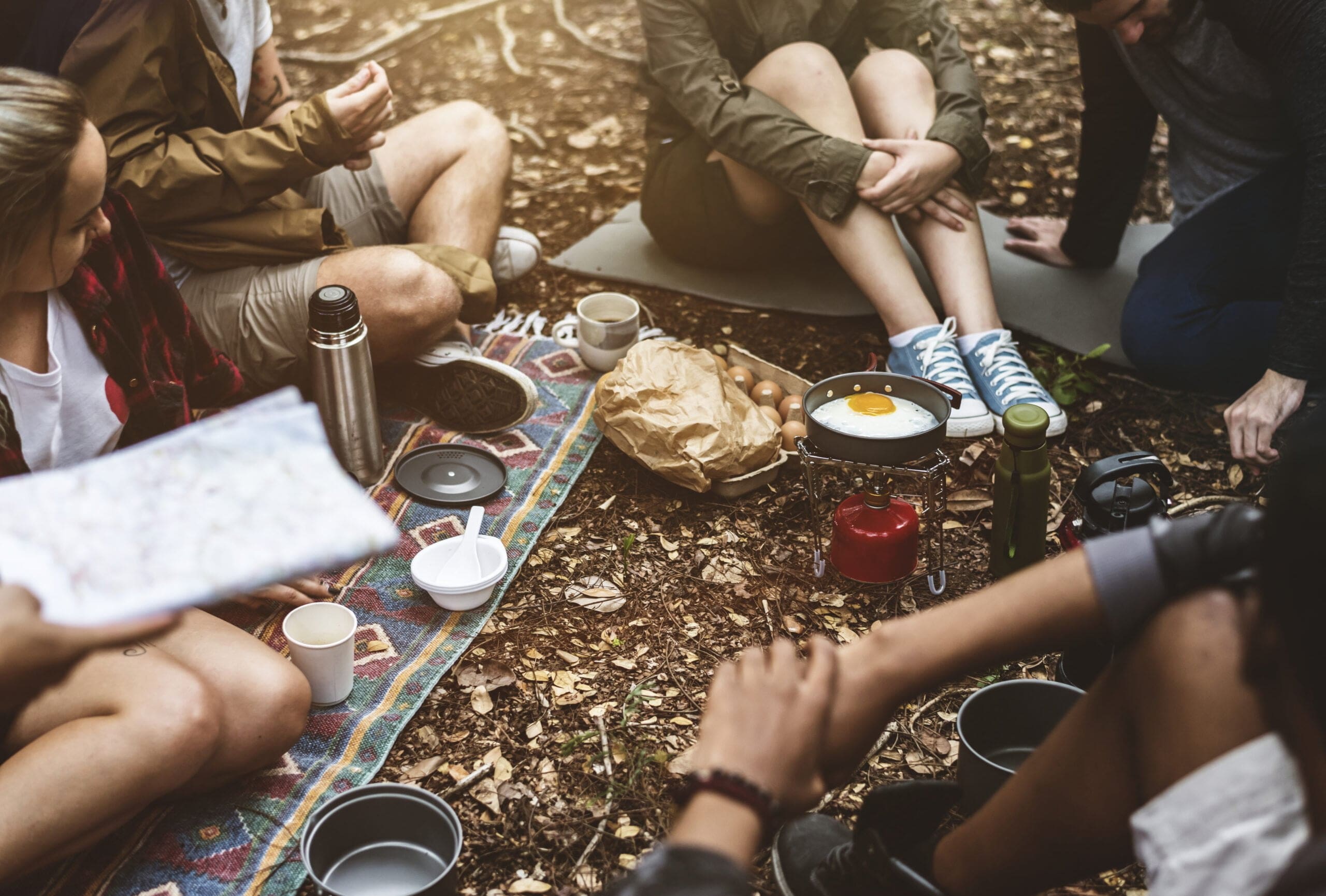 preparing food around the fire at camping