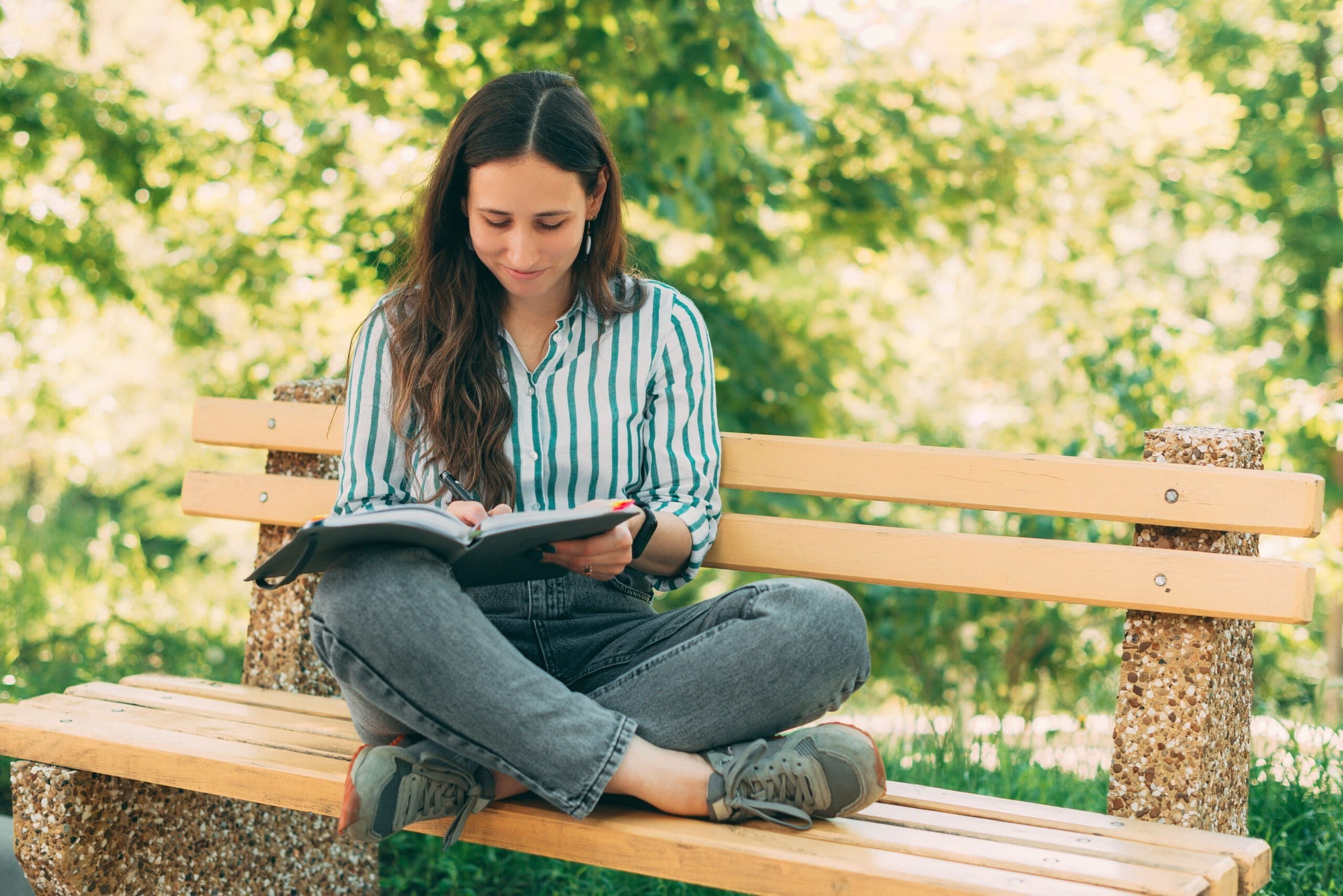 woman reading on backyard bench