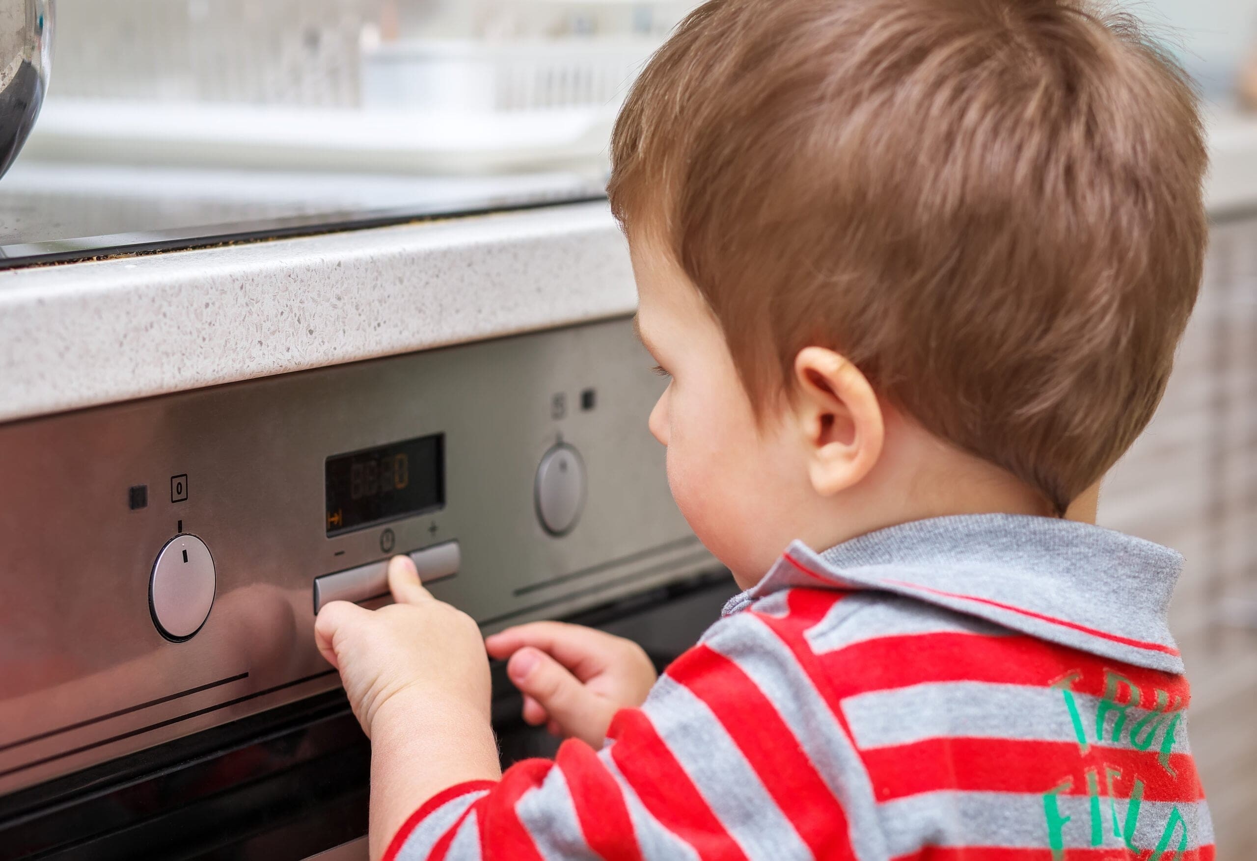 dangerous-situation-kitchen-child-playing-with-electric-oven