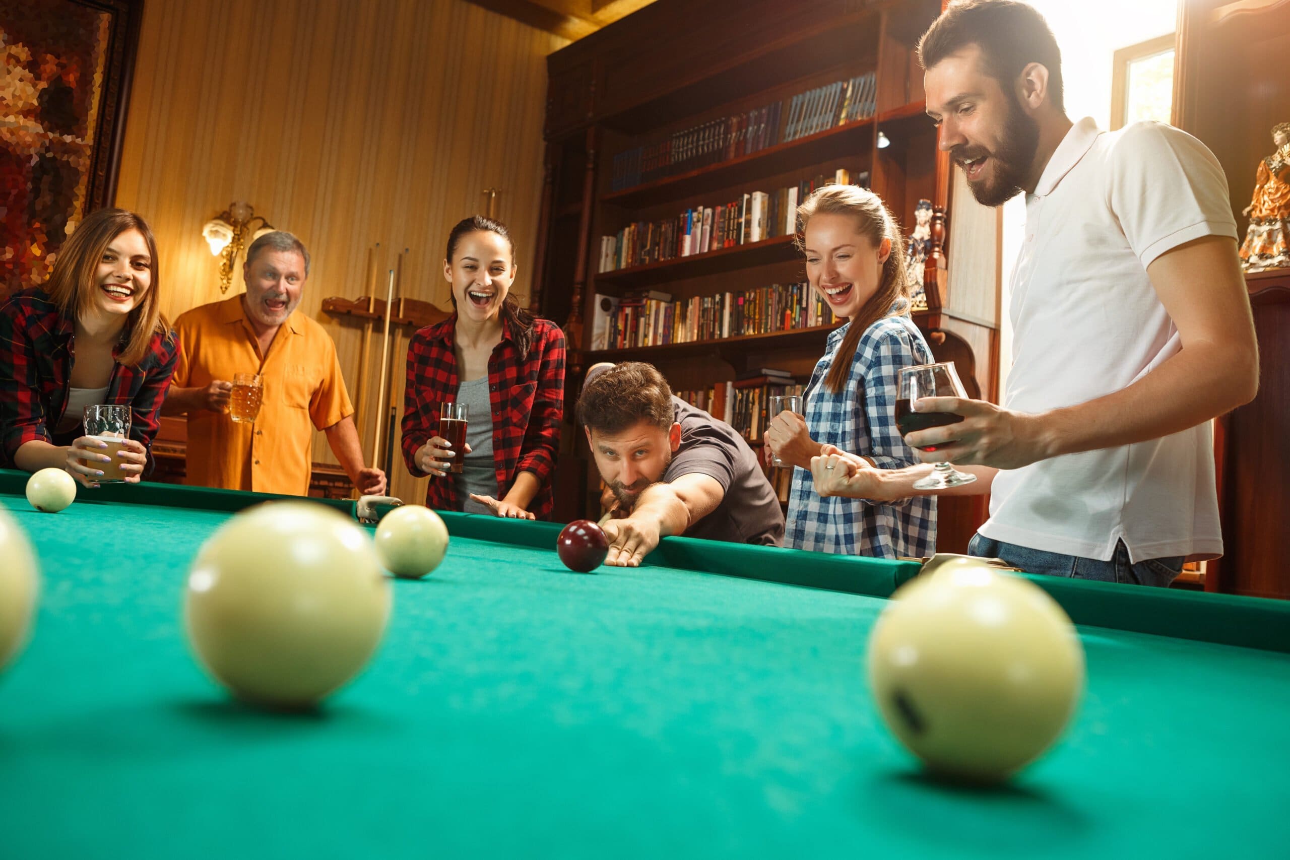 young-men-women-playing-pool=in-game-room-at-home