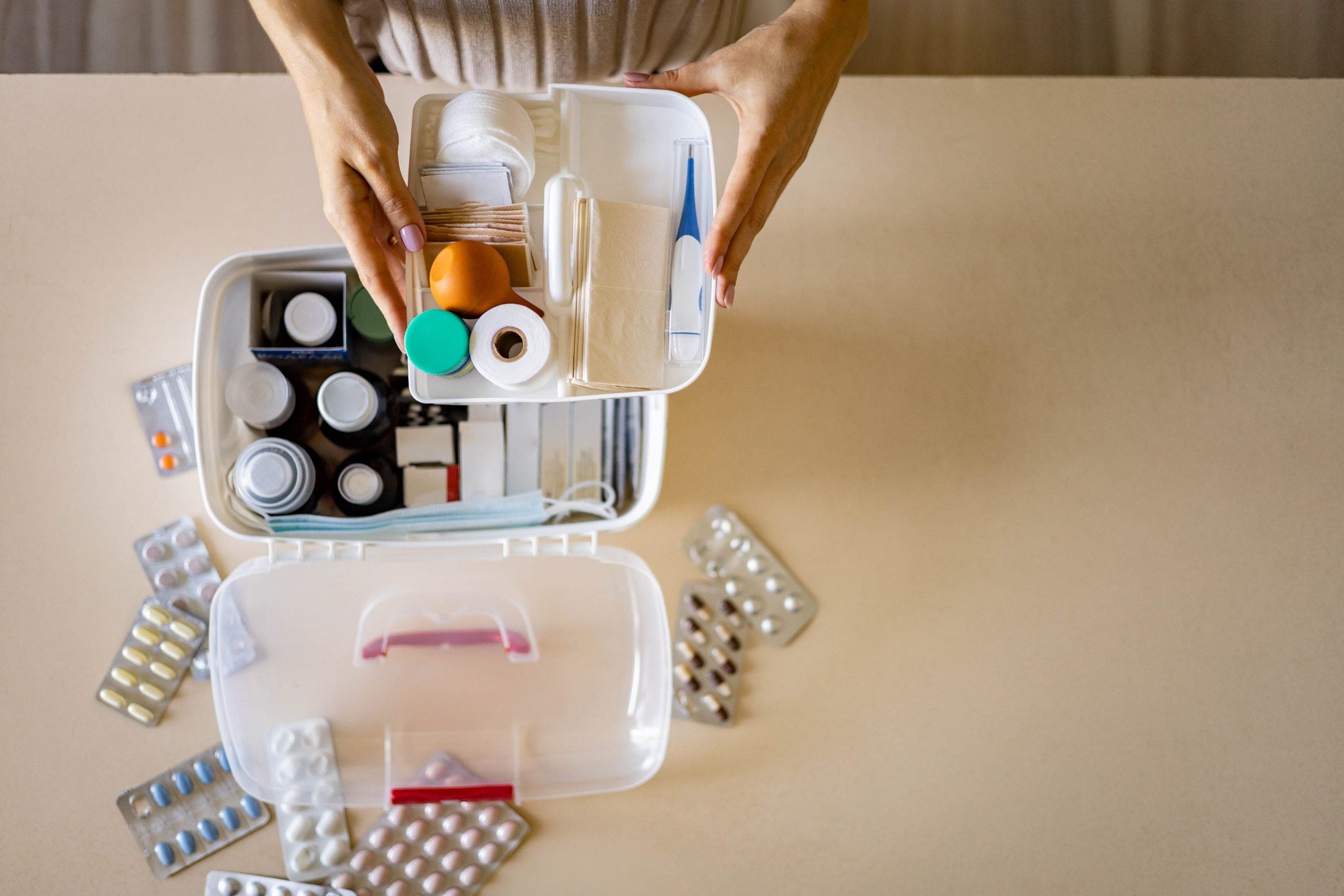 closeup-female-hand-placing-medicament-domestic-first-aid-kit-storage-organization-emergency-supply