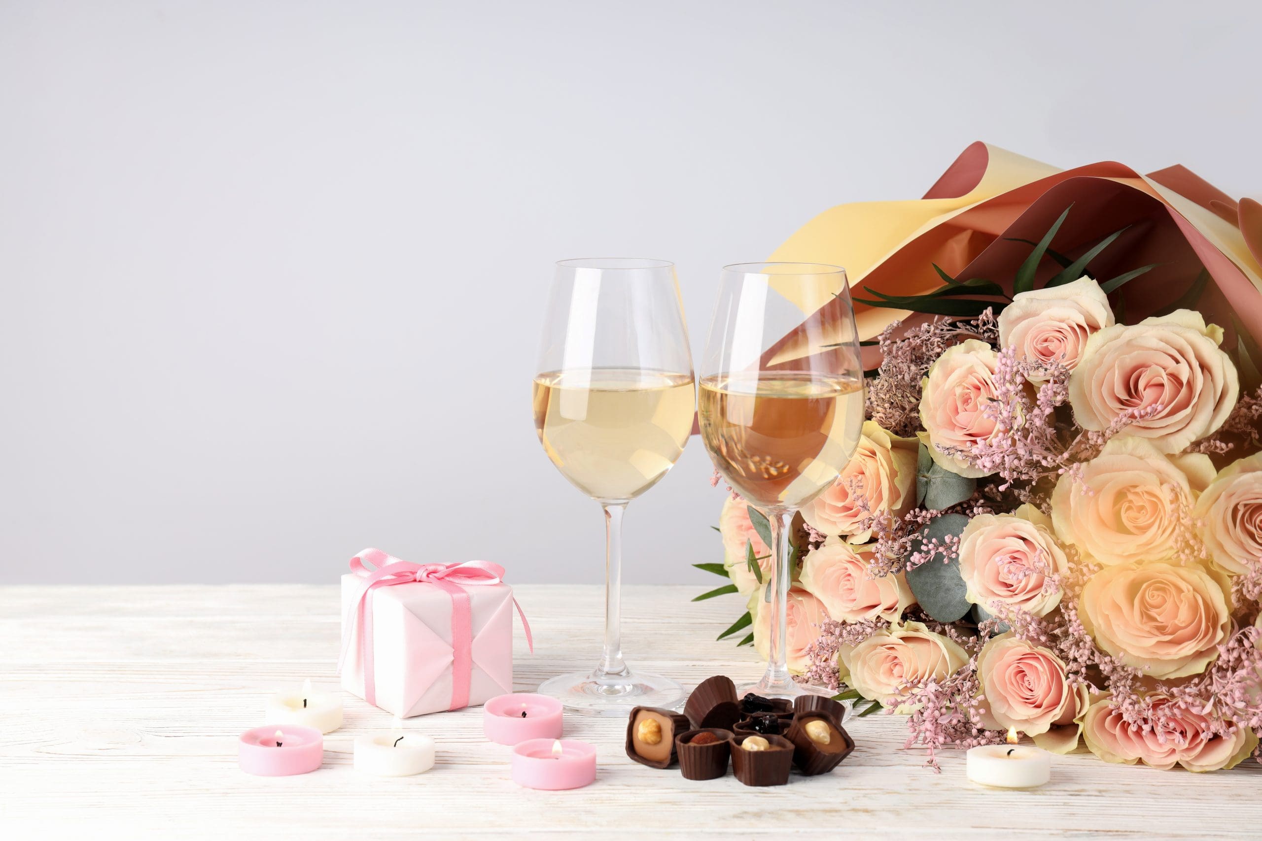 presents, wine, and flowers for couples finding ways to celebrate valentines day at home
