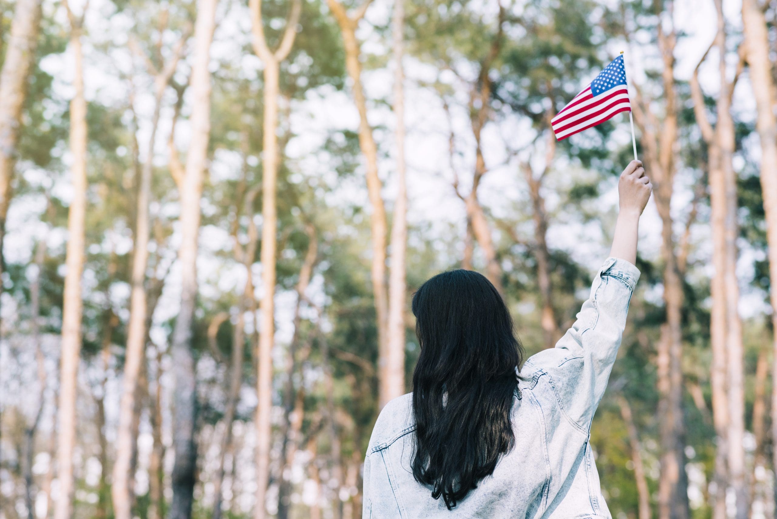 Woman waving american flag in honor of memorial day