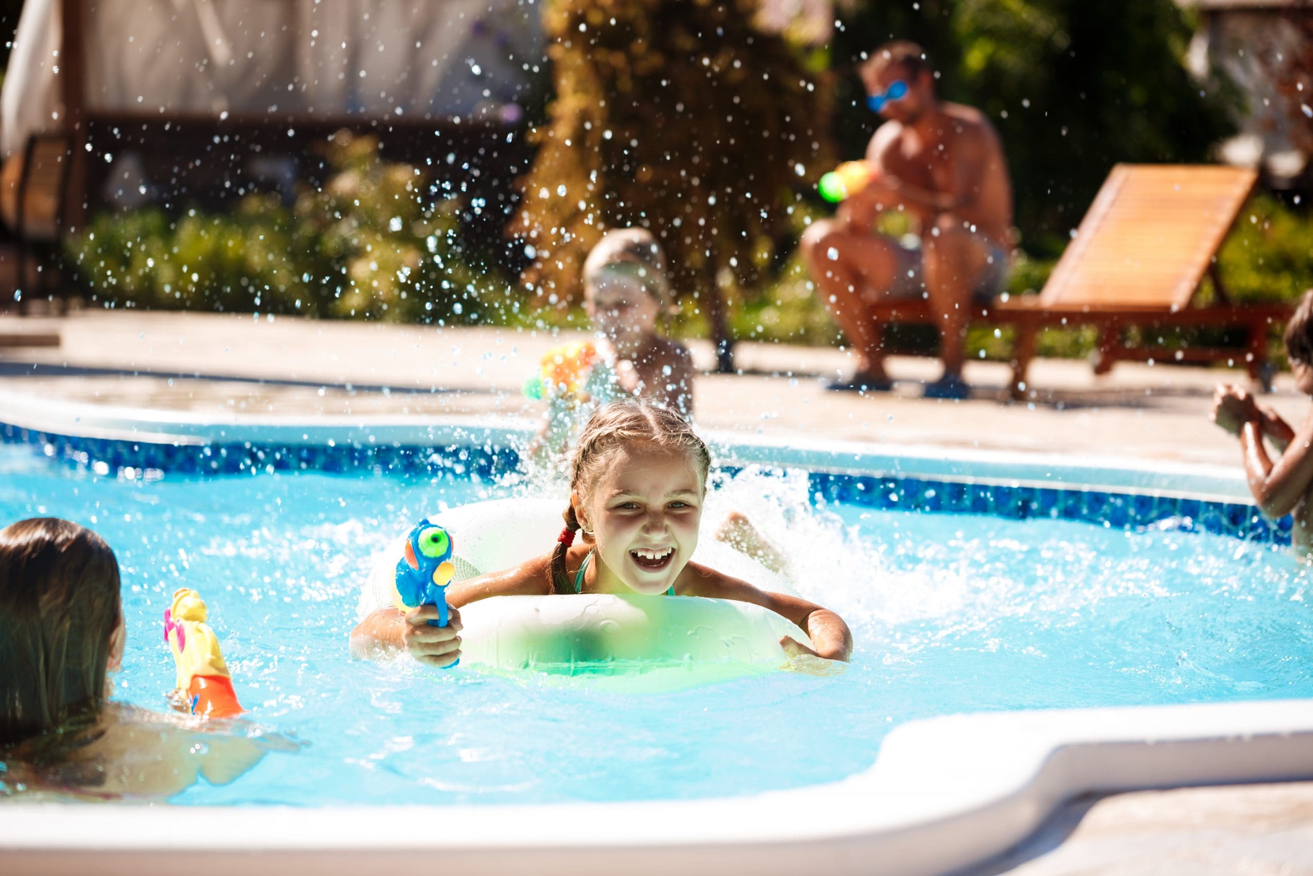 children laughing and playing in clean and maintained swimming pool
