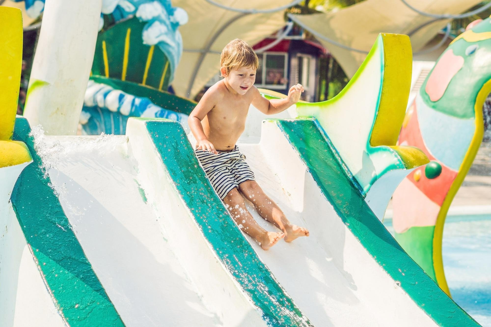 boy having fun on water slide at one of the water parks near saratoga county