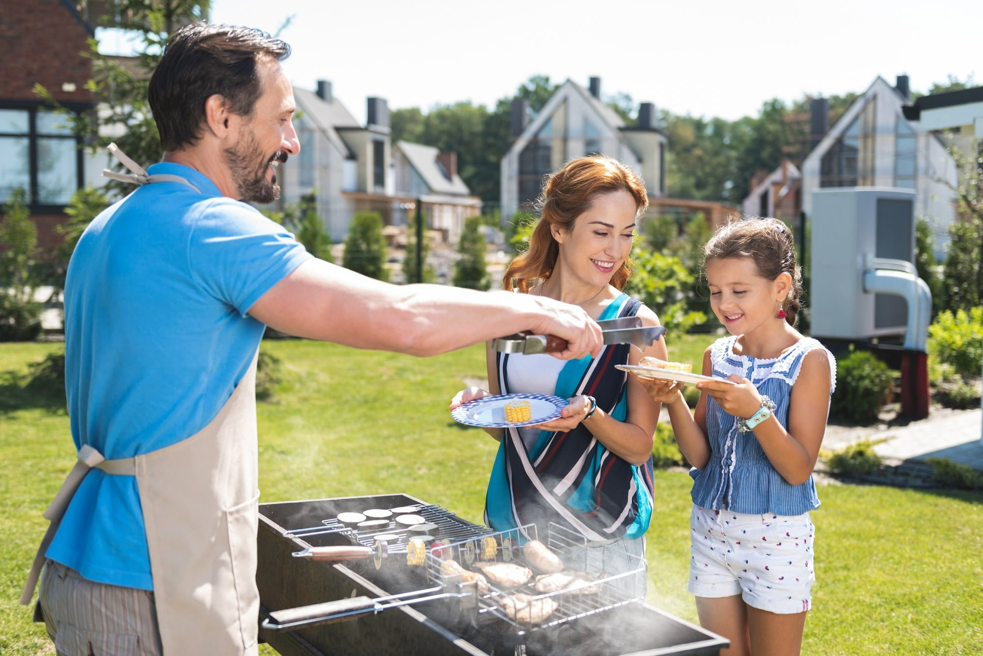 family outside with dad making kid-friendly grilling recipes