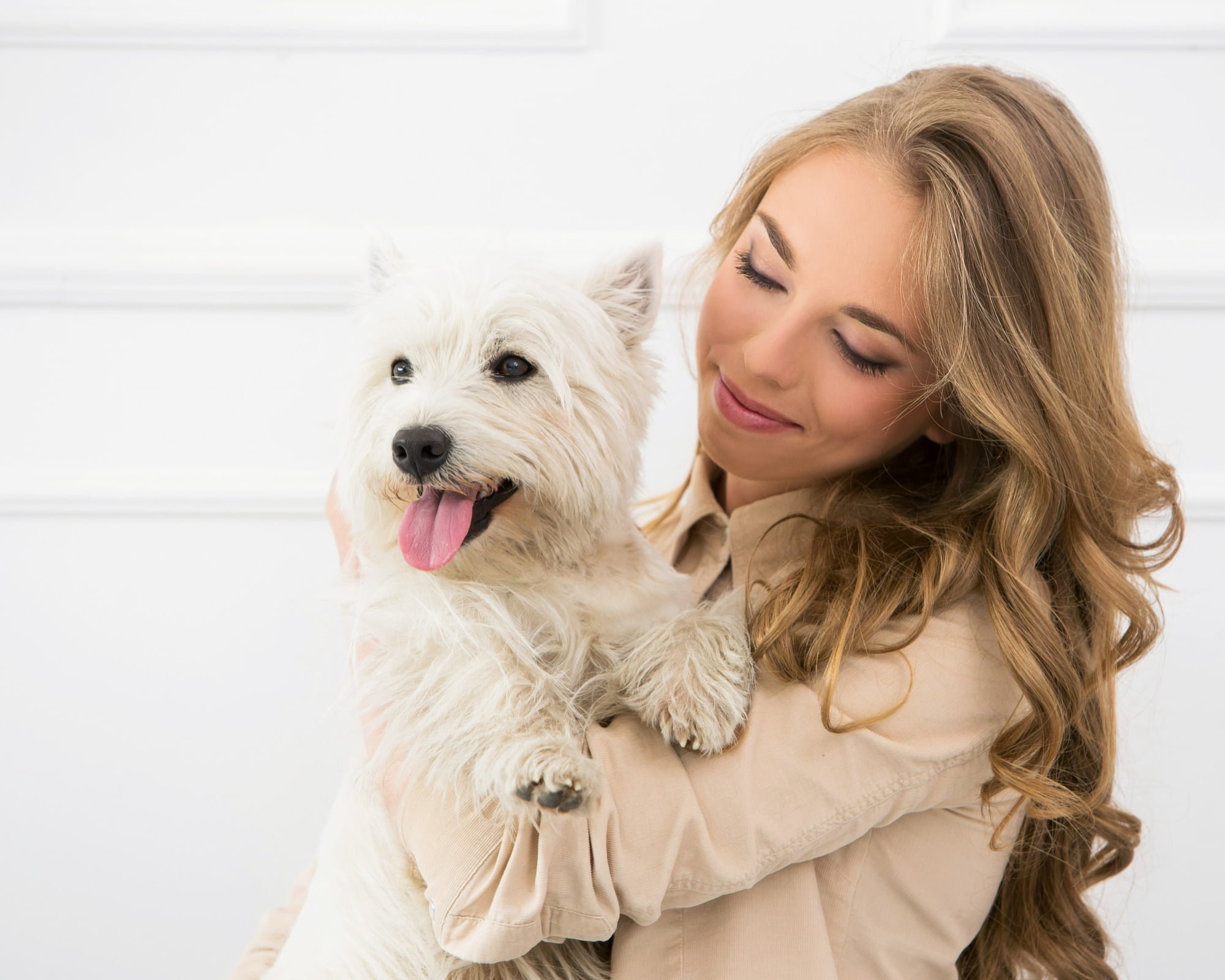 young woman pet sitter with small white fluffy dog