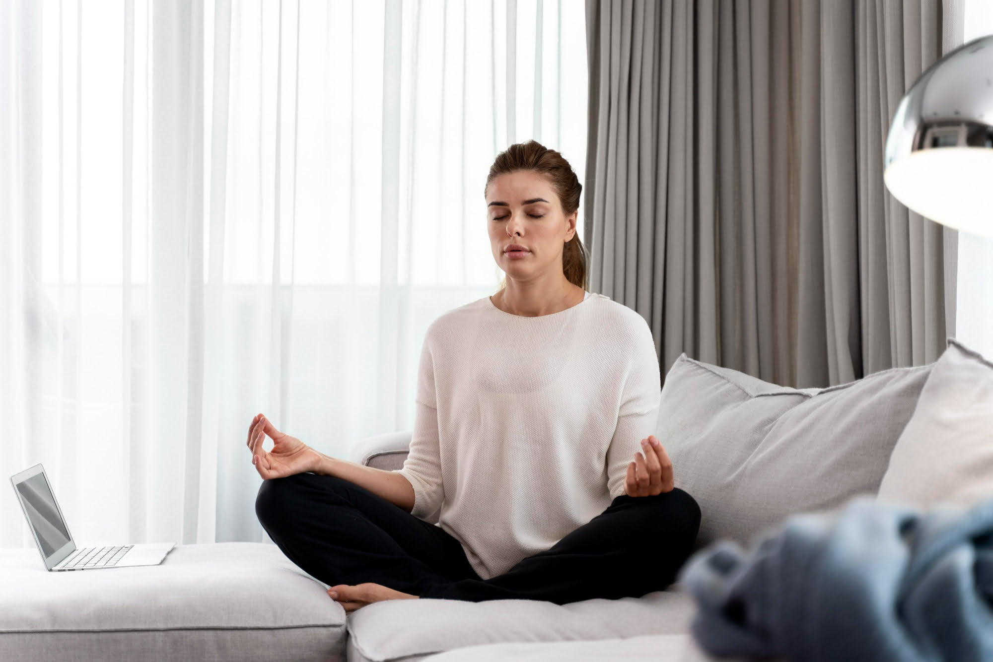 young-woman-practicing-yoga-as-one-of-the-at-home-mental-health-hacks.